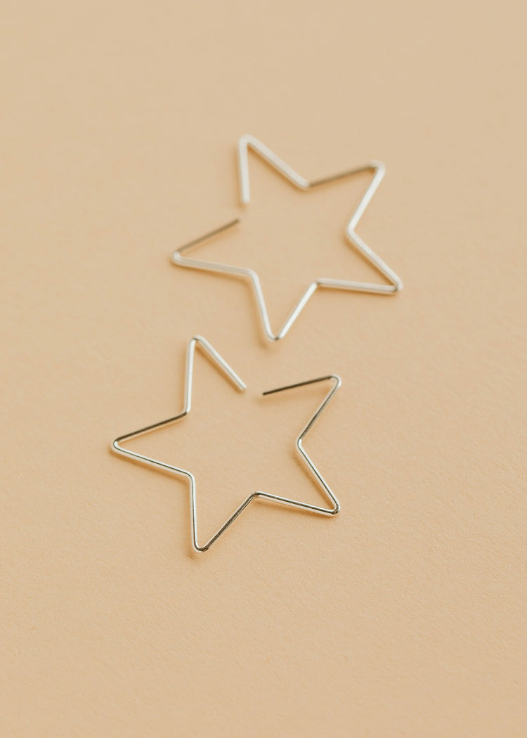 Hello Adorn Star Threader Earrings in Sterling Silver shown flat with a polished background.