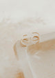 Close-up of tiny twist earrings