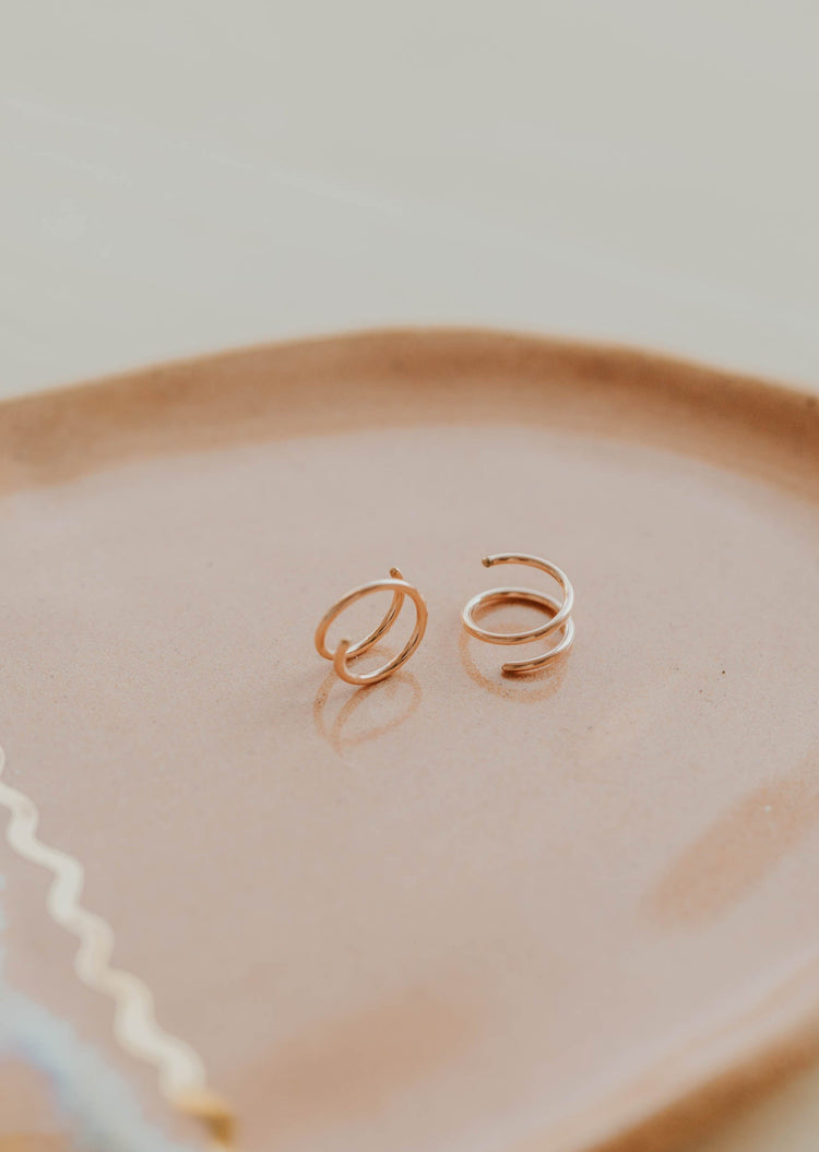 Close-up of tiny twist earrings