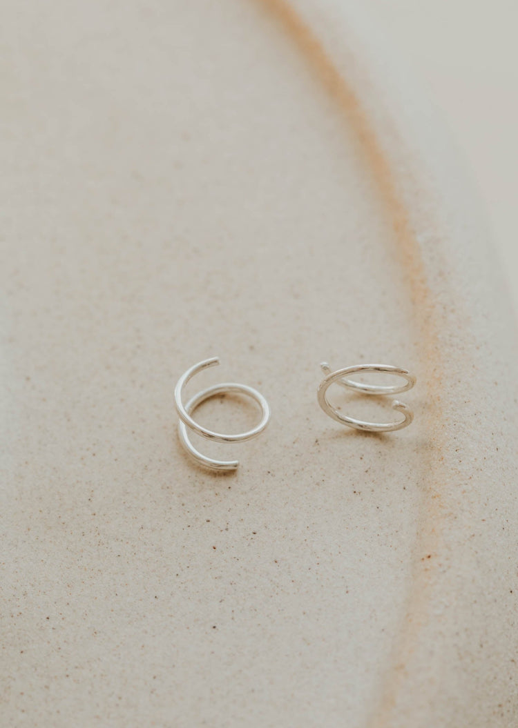 Close-up of tiny twist earrings