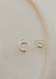 Close-up of tiny twist earrings