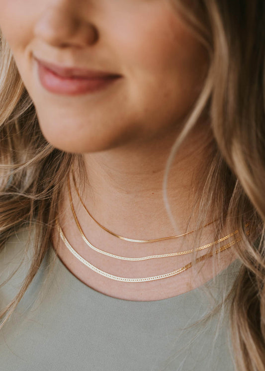 Layering gold chain necklace in Herra style by Hello Adorn shown in three different lengths.