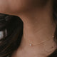 A freshwater pearl necklace handmade by Hello Adorn, a tiny freshwater pearl is attached to a delicate gold necklace chain creating this tiny pearl necklace.