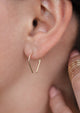 Tiny horseshoe threader earrings by Hello Adorn shown with midi wrap ring.