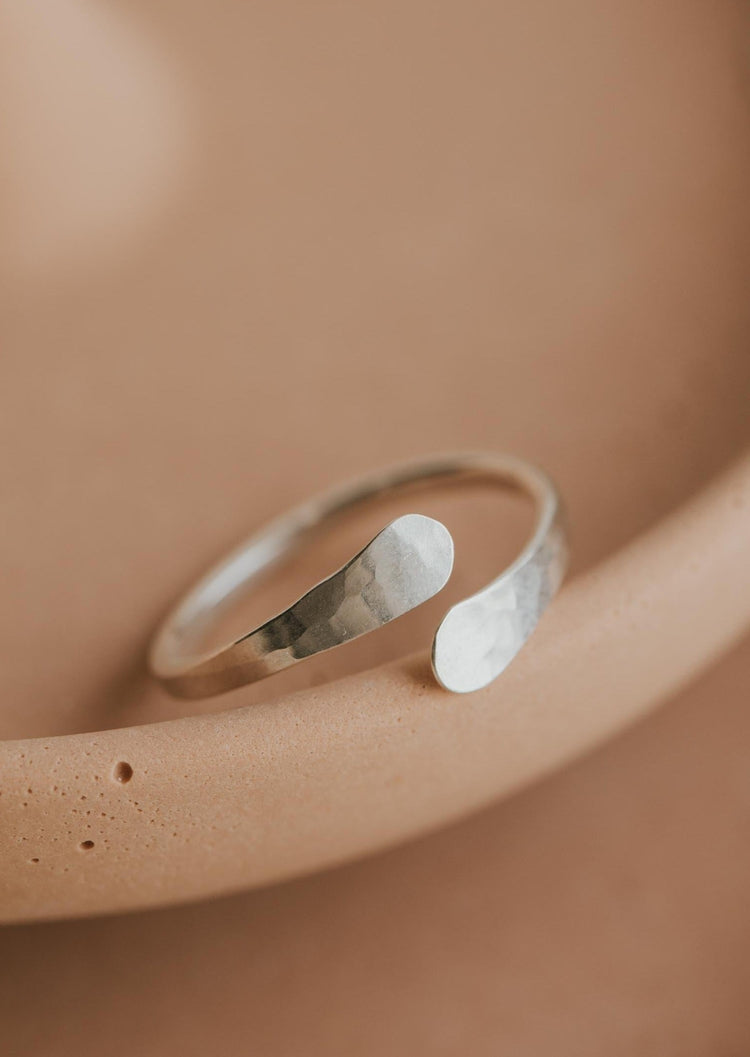 A Sterling Silver wrap ring shown in a hammered texture ring perfect if you're looking for an open ring to add to your ring stack by Hello Adorn.