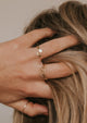 A cuff wrap Sonder ring in 14kt Gold Fill is stacked beautifully with other minimalist rings.