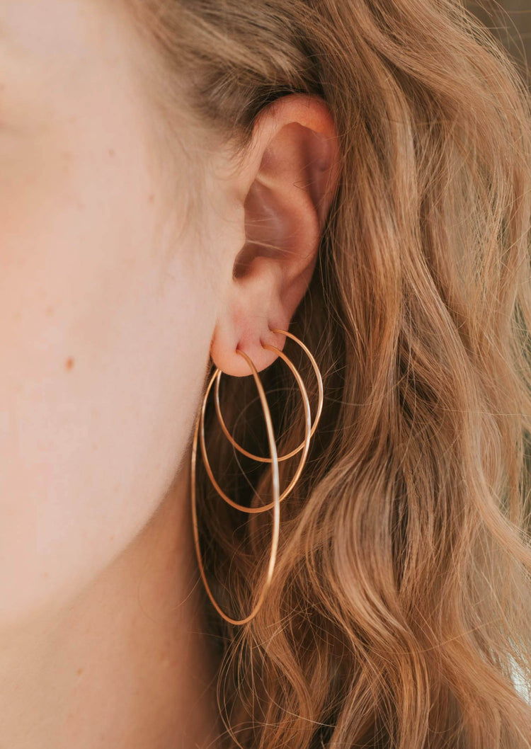 Three sizes of Cypress Hoops shown from largest hoop earrings to smallest hoop earrings created by Hello Adorn for simple gold earrings for daily use.