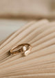 A wrap around ring in 14k gold fill that looks like an open ring handmade by Hello Adorn in a hammered texture ring style.