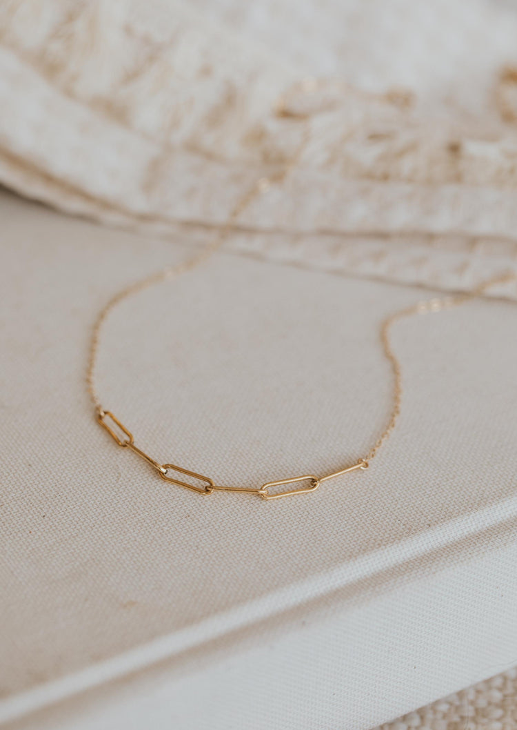 A close look at the Linked Necklace from Hello Adorn, a chain linked necklace with paperclip chains attached to a dainty chain necklace.
