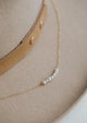 A pearl necklace from Hello Adorn, a dainty chain with pearls attached to create a statement necklace.