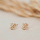 Handmade jewelry using herkimer diamonds shown close-up in 14k gold fill to create diamond quartz stud earrings by Hello Adorn.