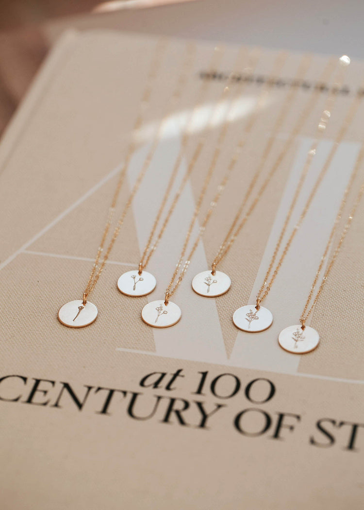 14kt Gold Fill wildflower necklaces that are custom stamped with unique floral stems representing your childrent.