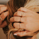 Stackable ring ideas by Hello Adorn, this stack features two hammered rings, a wire wrapped ring, a statement ring as a textured ring, and a gold chain ring.