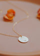 A body positive necklace charm of a hand-stamped feminine silhouette outline on a 14kt Gold Fill disc pendant.