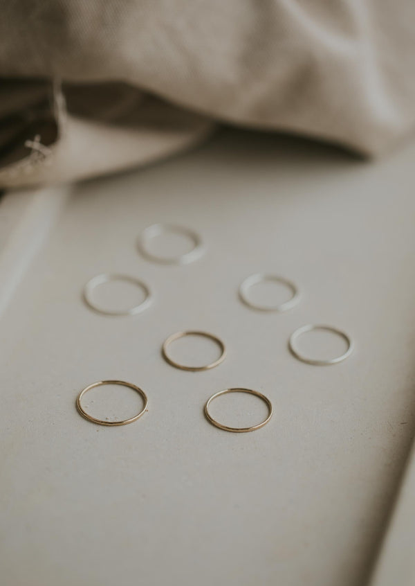 Silver thin rings and gold thin rings shown with a hammered texture used for stacking rings in 14k gold fill and sterling silver jewelry by Hello Adorn.