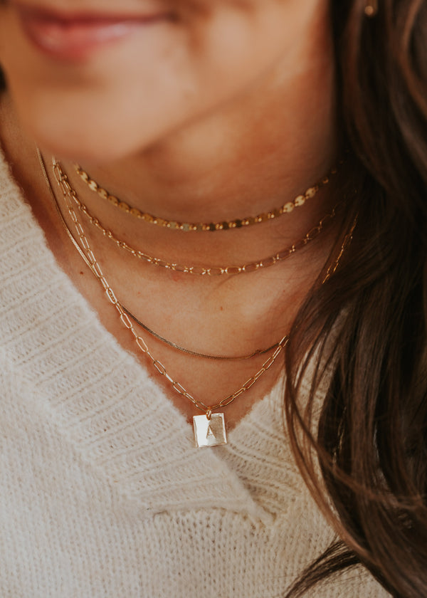 14kt Gold Fill layering necklaces and chains on a young model.