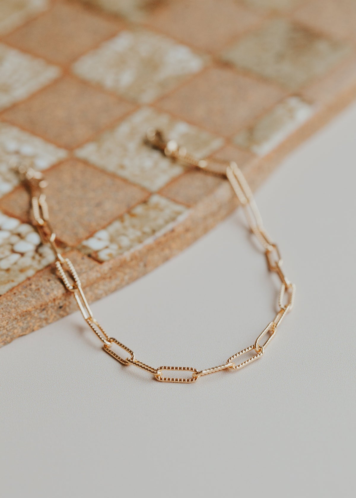 A 14kt Gold Fill patterned link chain bracelet.