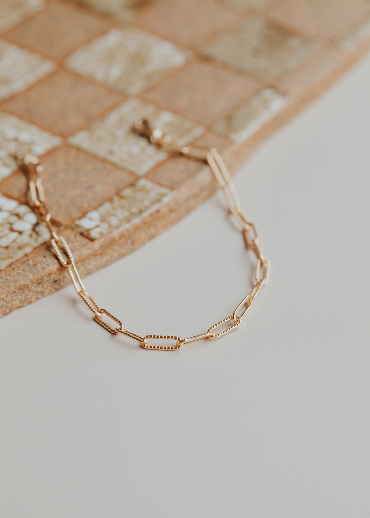 A 14kt Gold Fill patterned link chain bracelet.