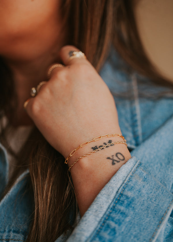 14kt Gold Fill minimalist chain bracelets on a young model with tattoos.
