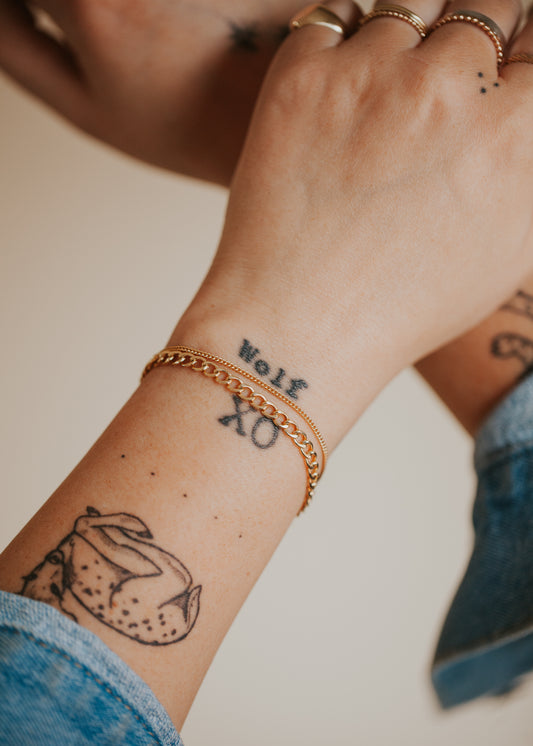 Styled 14kt Gold Fill bracelets layered over beautiful arm tattoos.