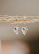A dagger-shaped, faceted, crystal quartz stone is wire-wrapped and attached to a 14kt Gold Fill endless hoop earring. 