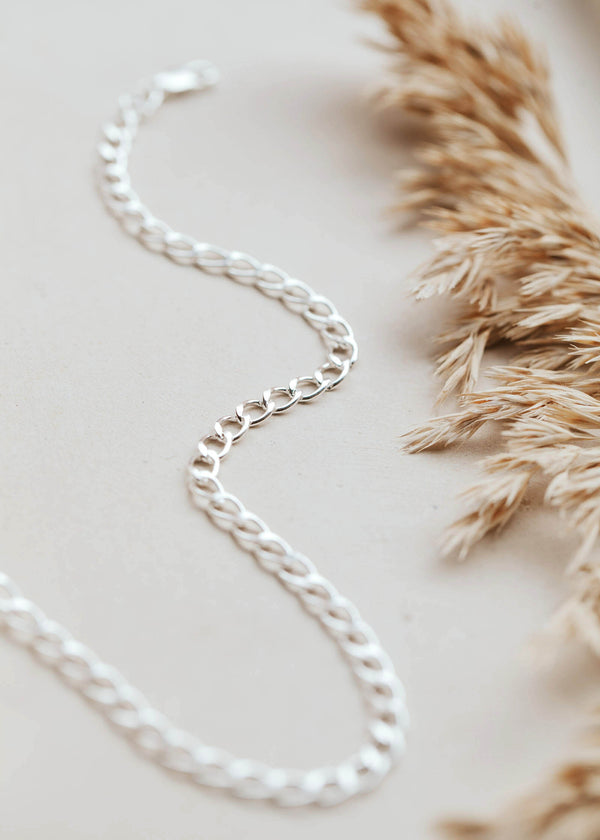 A bold curb chain choker in Sterling Silver.
