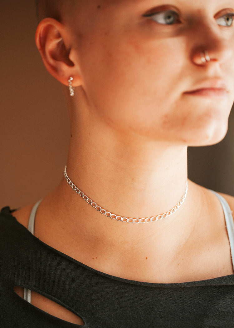 A chunky bold curb chain choker in Sterling Silver on a young girl.