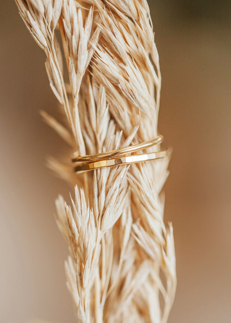 Two stackable rings, one is a gold hammered ring and the other is a gold thin ring created by Hello Adorn, dainty rings for your ring stack.