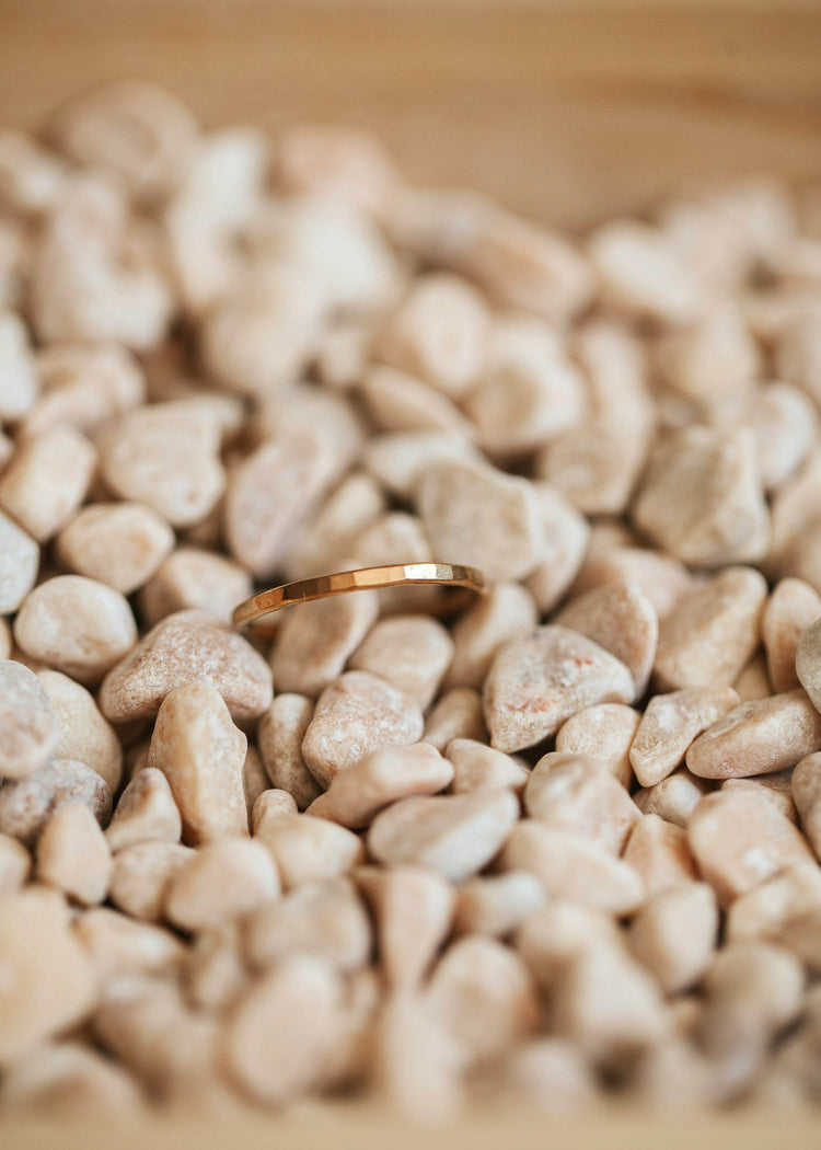 A close up look at the Aden Band by Hello Adorn, a simple ring design featuring a gold hammered ring to add to your stackable ring collection.