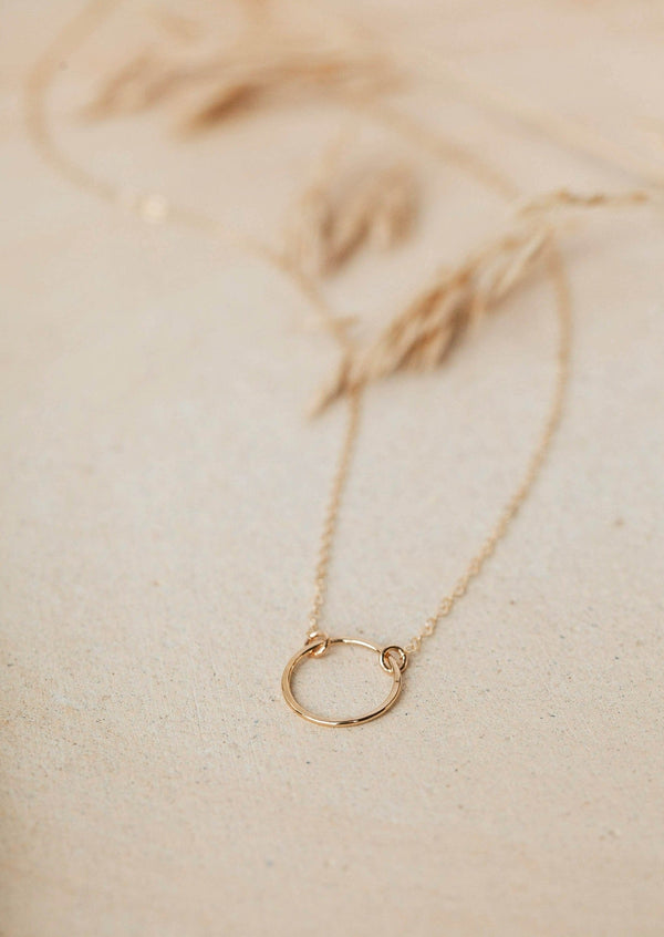 the Full Circle Necklace from Hello Adorn, a necklace of circles attached to a dainty gold chain, a perfect statement necklace.