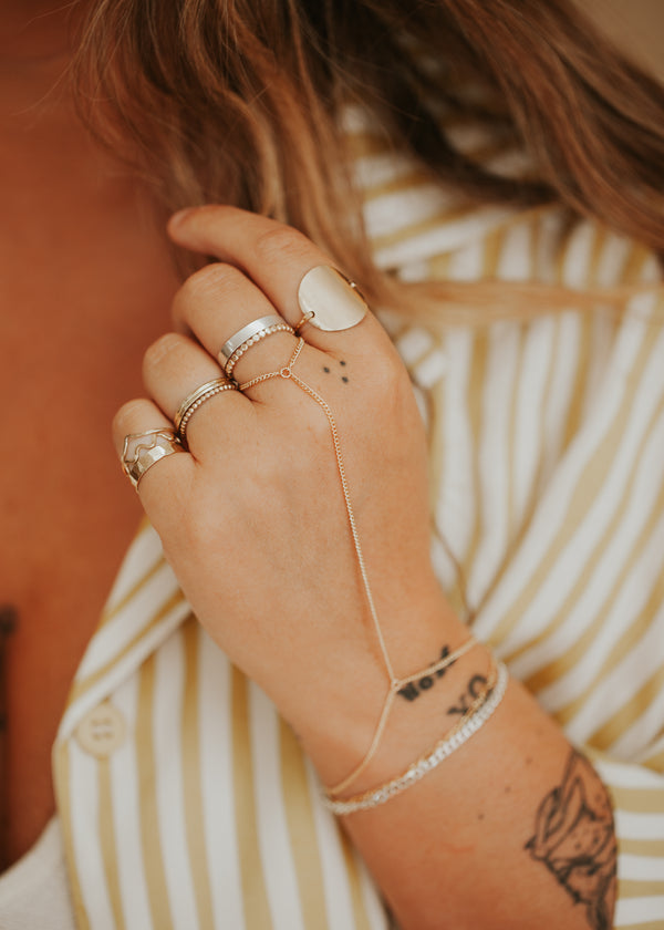14kt Gold Fill Hand Chain Ring on a young model with other ring stacks.