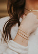A beautiful young lady wearing 14kt Gold Fill stack bracelets.