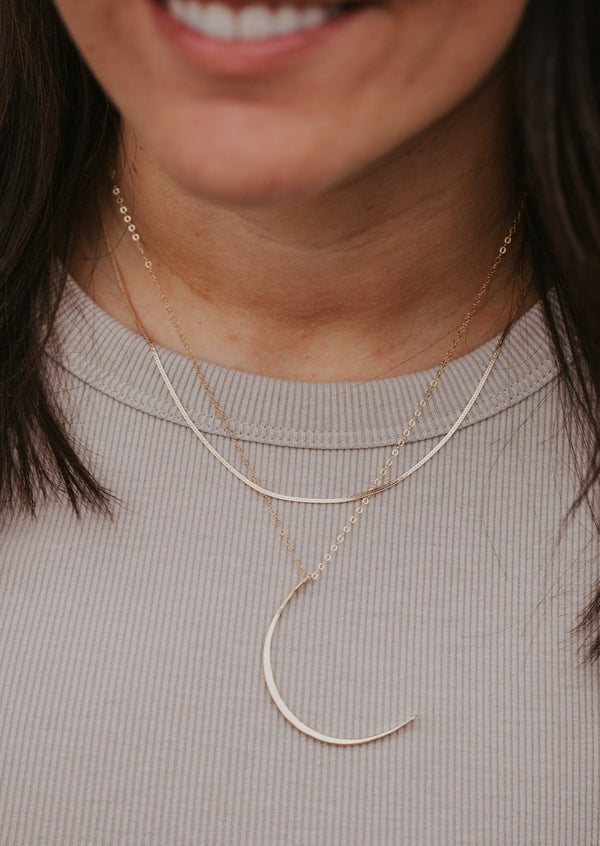 Gold Herra layering chain shown in necklace layering with crescent moon necklace by Hello Adorn.