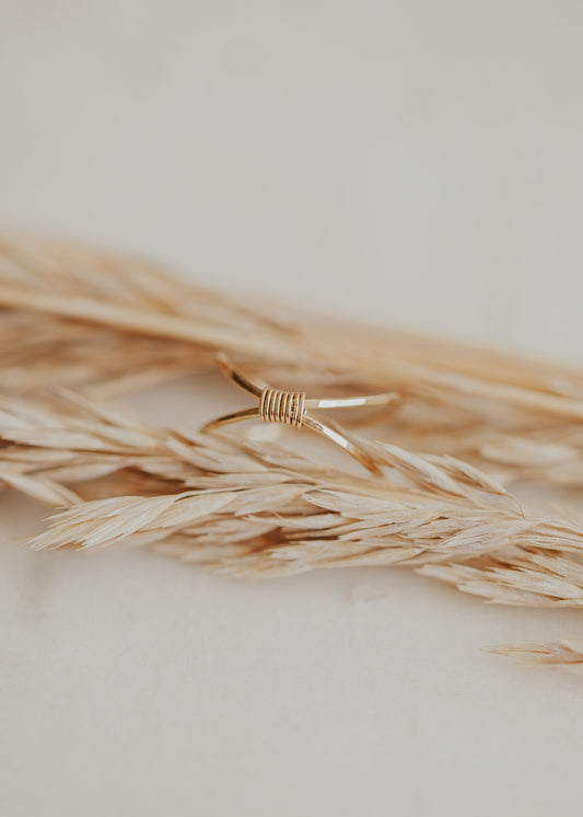 A wire wrapped ring made with two gold hammered rings to create the Cleo Ring by Hello Adorn.