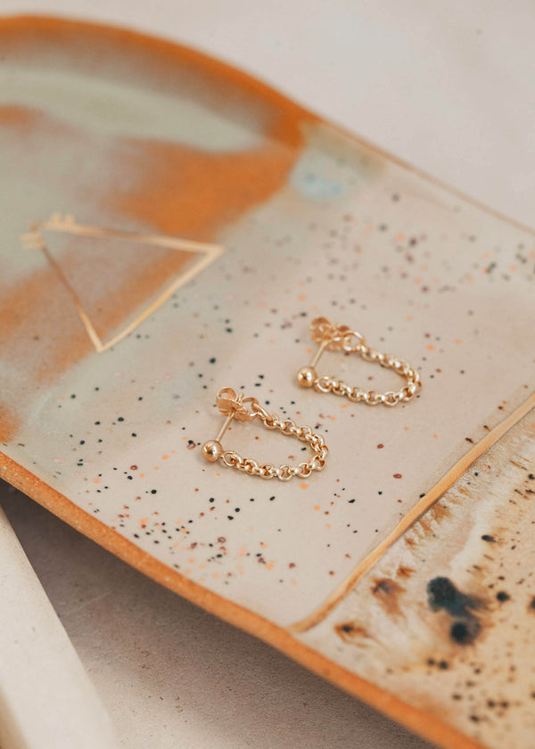 Gold chain stud earrings by Hello Adorn in mini annex style made as a hanging chain earring.