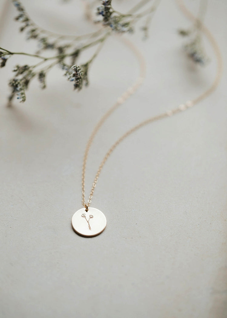 A 14kt Gold Fill charm necklace that is lightly brushed and hand-stamped with a custom wildflower bouquet.