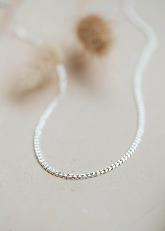 A neutral flat curb chain choker in Sterling Silver.