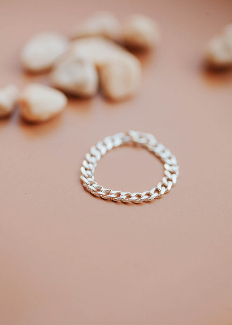 A bold and neutral Sterling Silver flat curb chain ring.