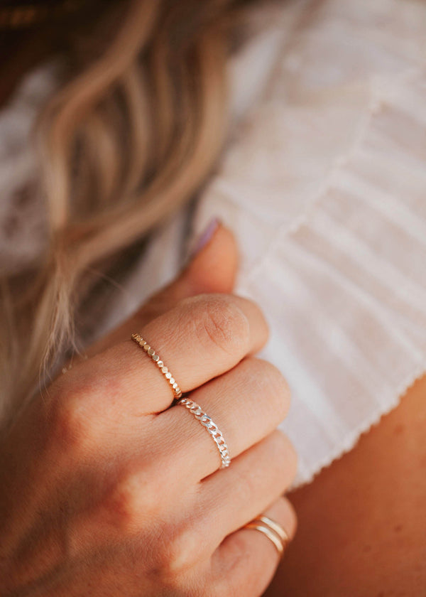 A Sterling Silver flat curb chain ring on a young girl.