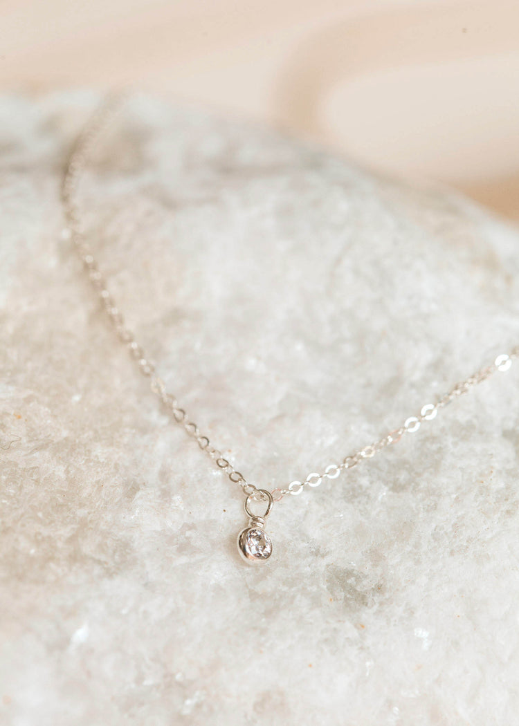 A sterling silver stone necklace handmade by Hello Adorn featuring a white stone in a bezel setting necklace diamond.