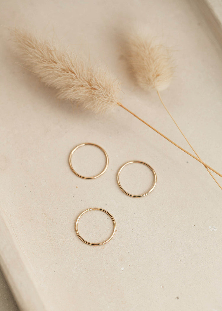 Tenny-Tiny Band By Hello Adorn laying flat in a group of three stacking rings.