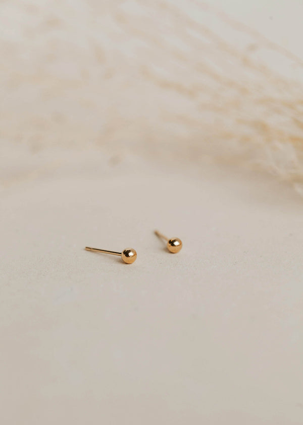 Gold ball earrings in a stud earring style created for everyday earrings or complete your earring stack with these gold small stud earrings by Hello Adorn.