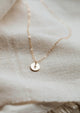 Tiny initial necklace that is hand stamped jewelry by Hello Adorn.