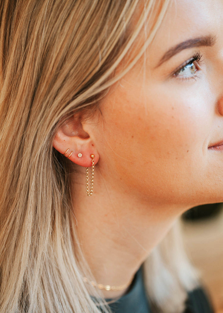 Circle stud earrings styled with gold ear cuff and annex studs in an ear by Hello Adorn.
