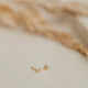 14k gold fill tiny dot studs by Hello Adorn laying flat.