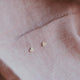 14k gold fill heart earrings shown as a stud earring great for adding to an earring stack by Hello Adorn.