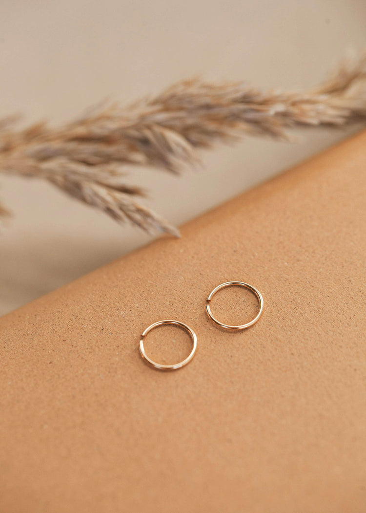 Gold Hoop Earring laying flat by Hello Adorn great for minimalist jewelry.