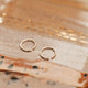 Gold hoop earring laying flat by Hello Adorn great for minimalist jewelry.