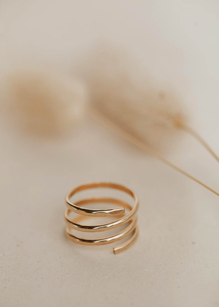 A triple wrap ring to look like 3 rings created by Hello Adorn shown in 14k gold fill, a statement ring to add to your ring stack.